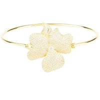 Gold cuff bracelet with large white flower cluster statement