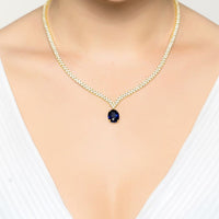 Gold tennis necklace with oval sapphire pendant