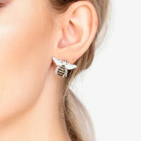 Silver honey bee stud earrings on ear, small crystal bee with wing sparkle