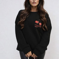 Black oversized knitted jumper with crew neck and small cherry graphic on front