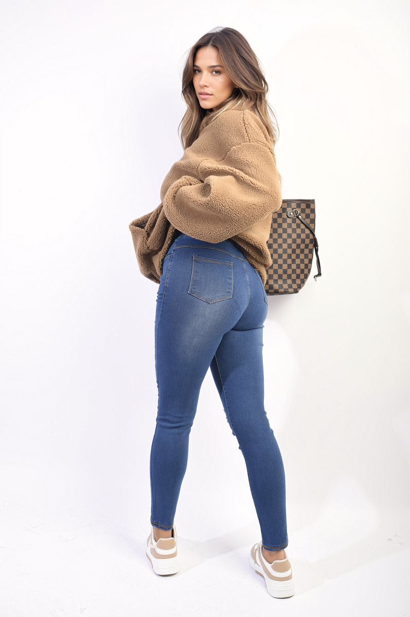 Denim blue high-waisted skinny jeggings with ripped knees and worn knee detailing