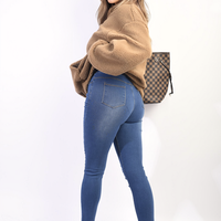 Denim blue high-waisted skinny jeggings with ripped knees and worn knee detailing