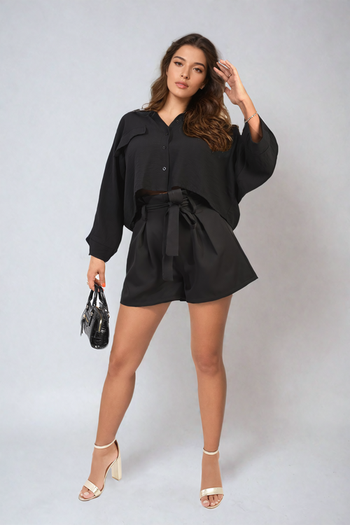 Black high-waist paper bag tie shorts with waist tie and gathered front.