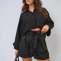 Black paper bag high-waist shorts with button front and tie belt at waist