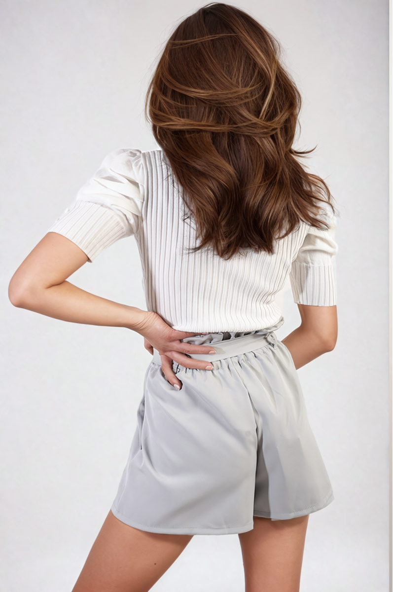Grey high-waist paper bag shorts with tie belt at the waist and side pockets