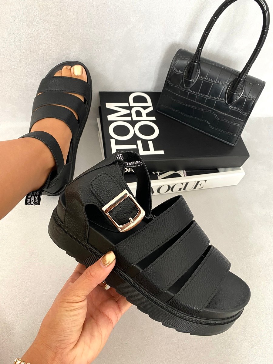 Black slide sandals with buckle strap and thick platform sole