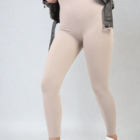 Apricot high-waisted leggings close-up, wide waistband and smooth fitted legs