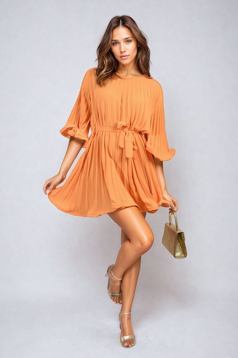 Orange pleated mini dress with tie waist and wide sleeves, flowing A-line skirt.
