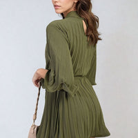 Olive green pleated mini dress with tie waist and wide sleeves, draped pleats.