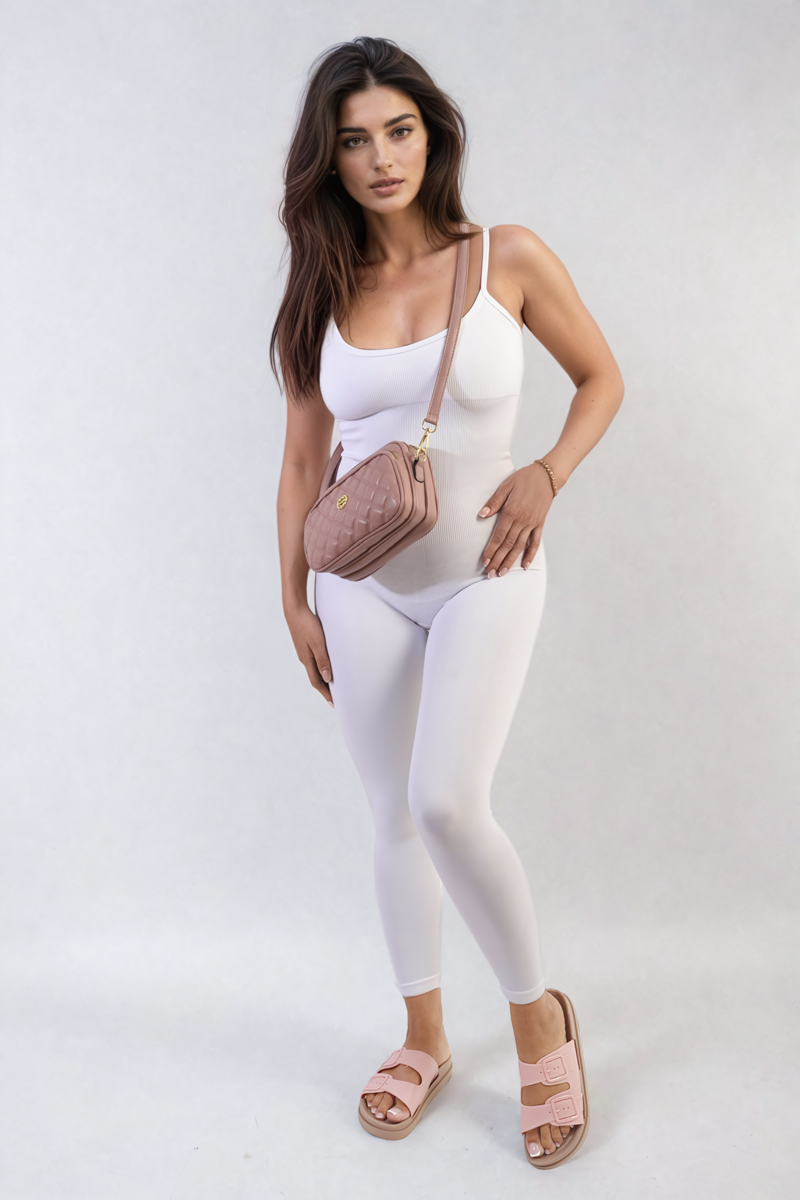 Fitted white scoop-neck jumpsuit with slim straps, standing three-quarter view