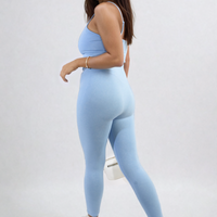 Sky blue bodycon jumpsuit with scoop neck and slim straps, close-fitting long leg