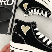 Kids black high-top lace-up trainers with gold heart patch and white midsole stripes