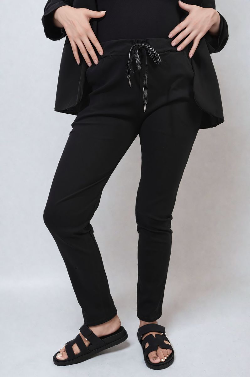 Black drawstring tapered trousers with side pockets, front close-up
