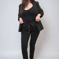 Black drawstring tapered trousers with side pockets, full body