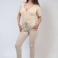 Beige drawstring tapered trousers with side pockets