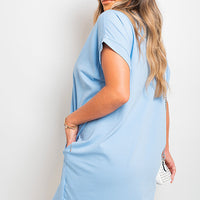 Short-sleeve top with front pockets, light blue tunic length, back view