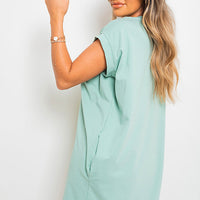 Light blue short-sleeve tunic top with loose drape and crew neckline