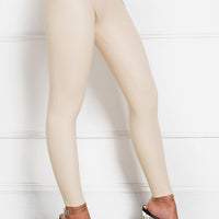 Beige faux leather leggings with slim straight leg silhouette and ankle-length cuff.