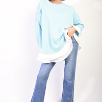 Oversized long-sleeve top in light blue with contrast ruffle hem and loose fit