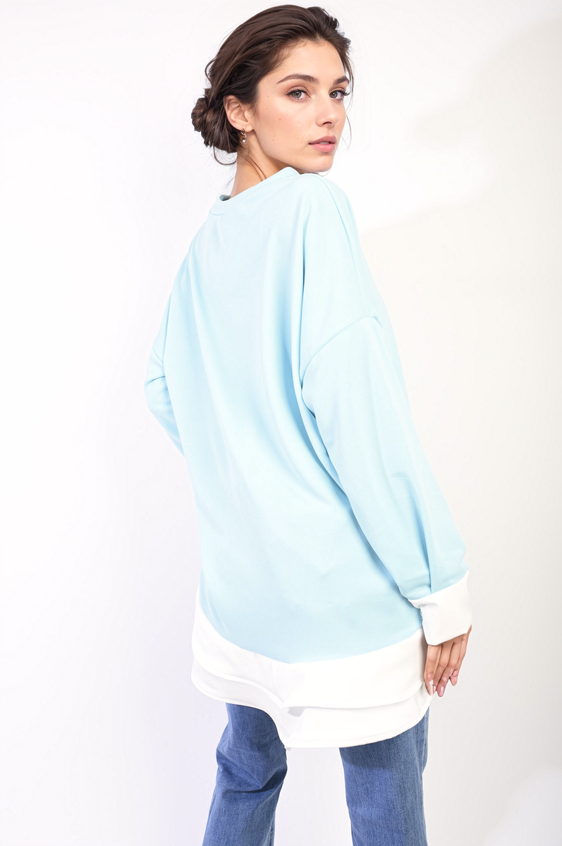 Sky blue long-sleeve oversized dress top with contrast ruffle hem, back/side view