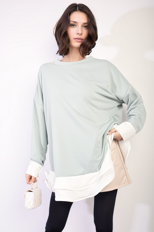 Mint green oversized long-sleeve top with contrast white ruffle hem