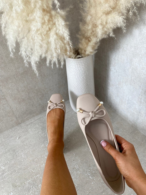 Beige ballet flats with bow and pearl bead trim, round toe, low heel