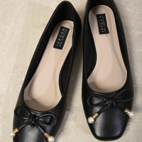 Black ballet flats, round toe, bow detail with pearl bead and gold accents