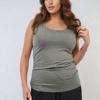 Scoop-neck green tank top with wide shoulder straps and gathered waist ruching