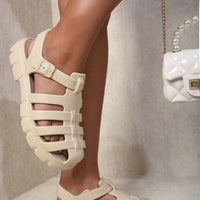 Beige chunky strappy sandals with round open toe and three horizontal strap bands