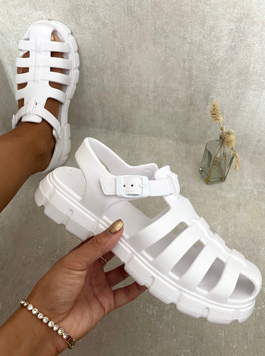 White chunky platform sandals with round open toe and adjustable buckled strap