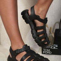 Black chunky strappy sandals with round open toe and adjustable buckle strap