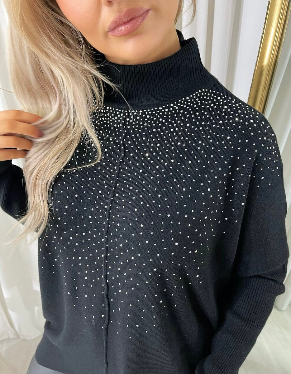 Black knitted jumper close-up with rhinestone-speckled yoke and high ribbed neck