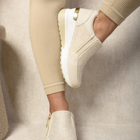 Beige rhinestone-front platform trainers with side zip and thick white sole