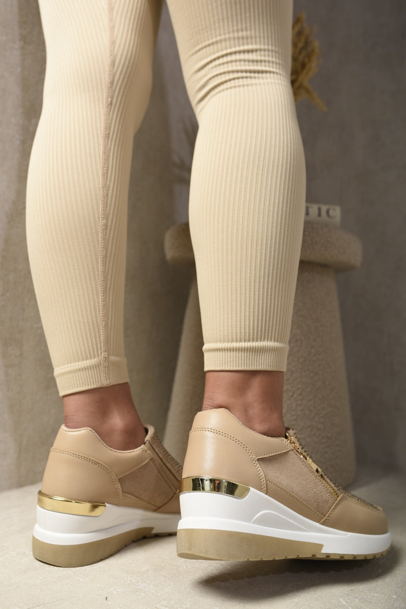 Beige platform trainers with gold heel detail and cushioned sole