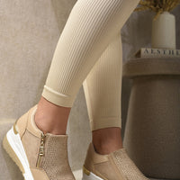 Beige platform trainers with rhinestone front and side zip, cushioned chunky sole