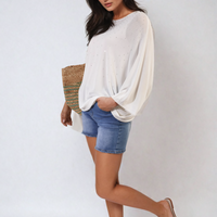 Oversized white round-neck top with subtle studded dot embellishment