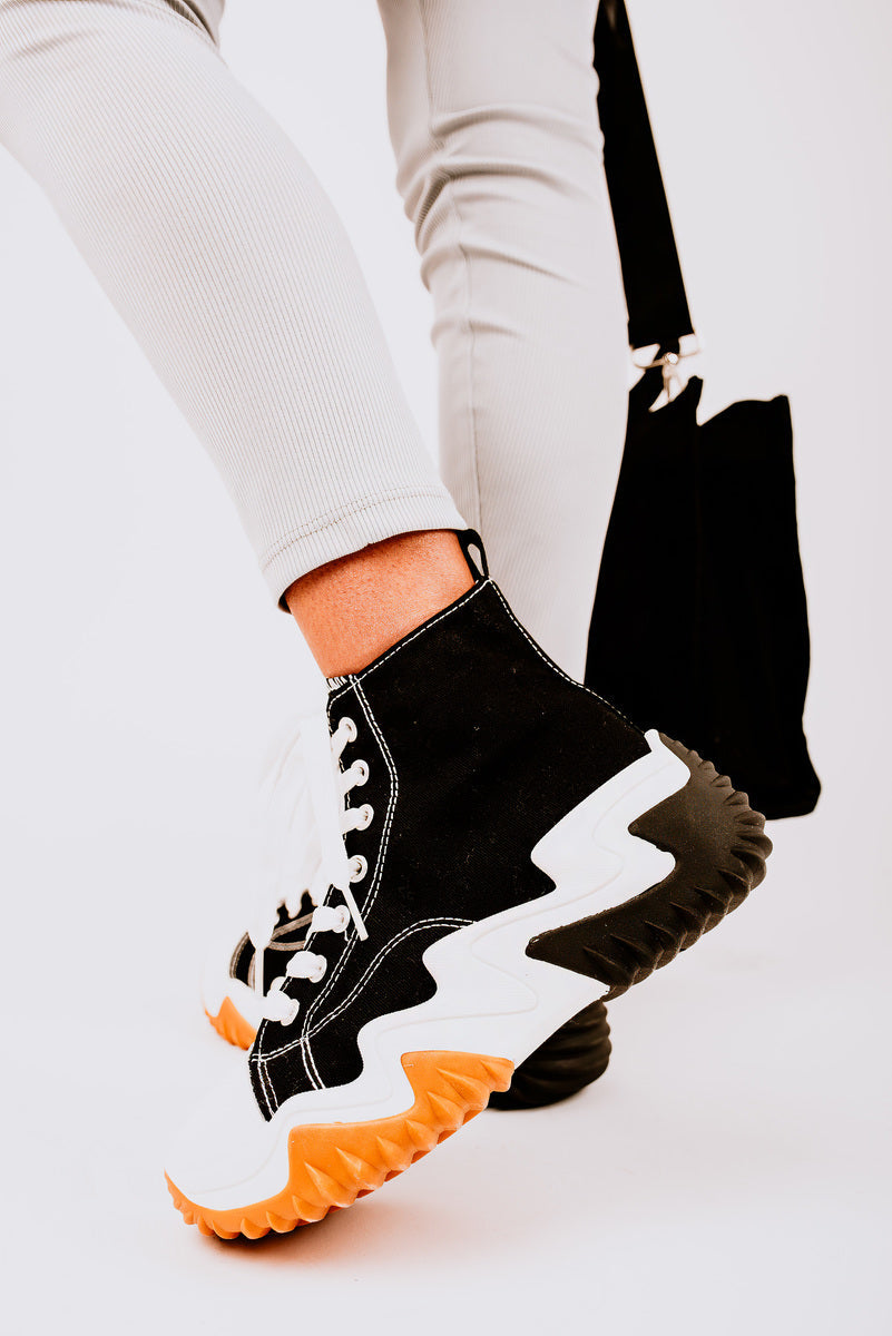 Black high-top platform trainers with white laces and chunky contrast sole