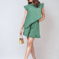 Green ruffle-trim sleeveless top and matching tiered shorts set, back/side angle.