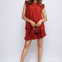 Red ruffle-trim sleeveless top and matching tiered shorts set, front view.