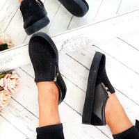 Black slip-on trainer pair with rhinestone-dotted upper, croc-effect panel, gold zip detail.
