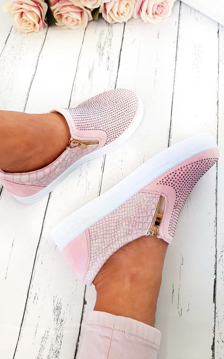 Pink slip-on trainer worn, diamante front with gold zip pull and croc-effect sides.