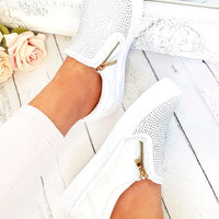 White slip-on trainer worn, diamante side panels and gold zip detail.