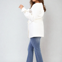 White belted blazer jacket side view with collared V-neck and tied waist