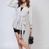 White belted blazer jacket with collar, long sleeves, V-neck front and tie belt