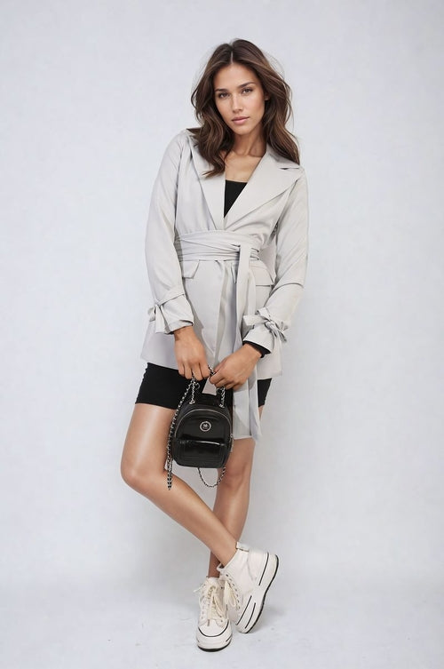 Pale grey collared blazer jacket with V-neck, long sleeves, and waist belt tie