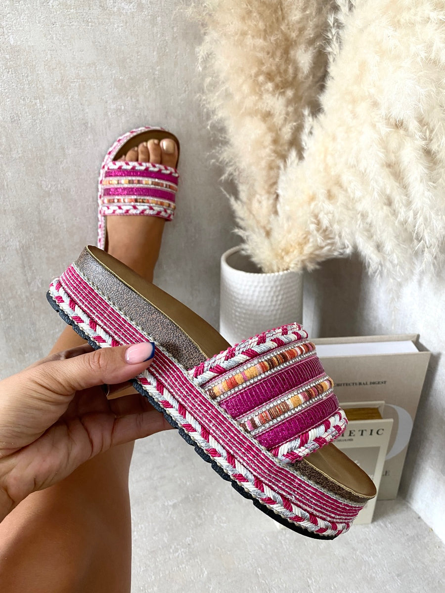 Platform slide sandals with pink woven straps, silver trim, and embellished braided edges