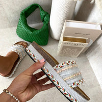 Platform slide sandals with light silver woven straps, textured braided trim, open toe