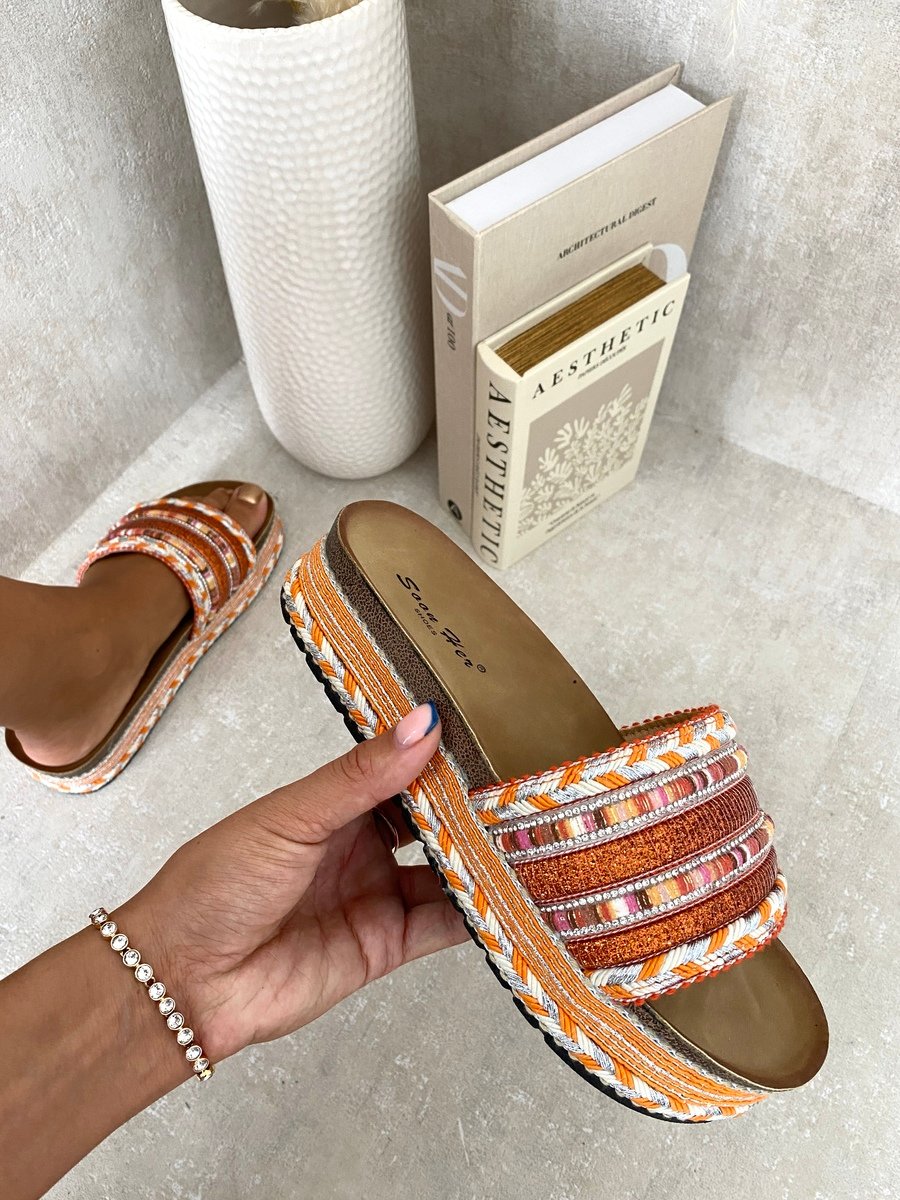 Platform slide sandals with orange woven straps and multicolor braided trim, open toe