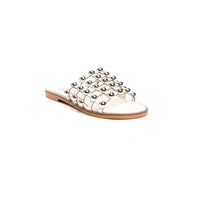 White flat slide sandals with silver studded lattice straps and open toe