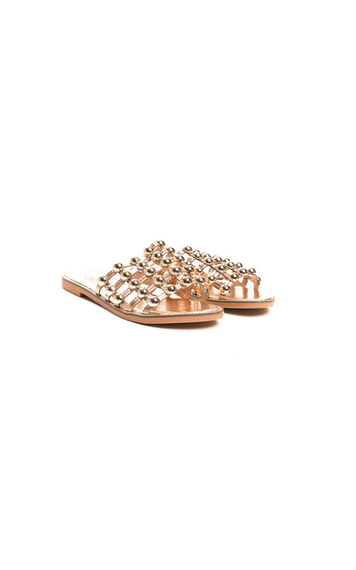 Rose gold flat slide sandals with studded lattice straps and open toe